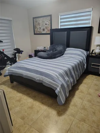 a bedroom with bed and a window