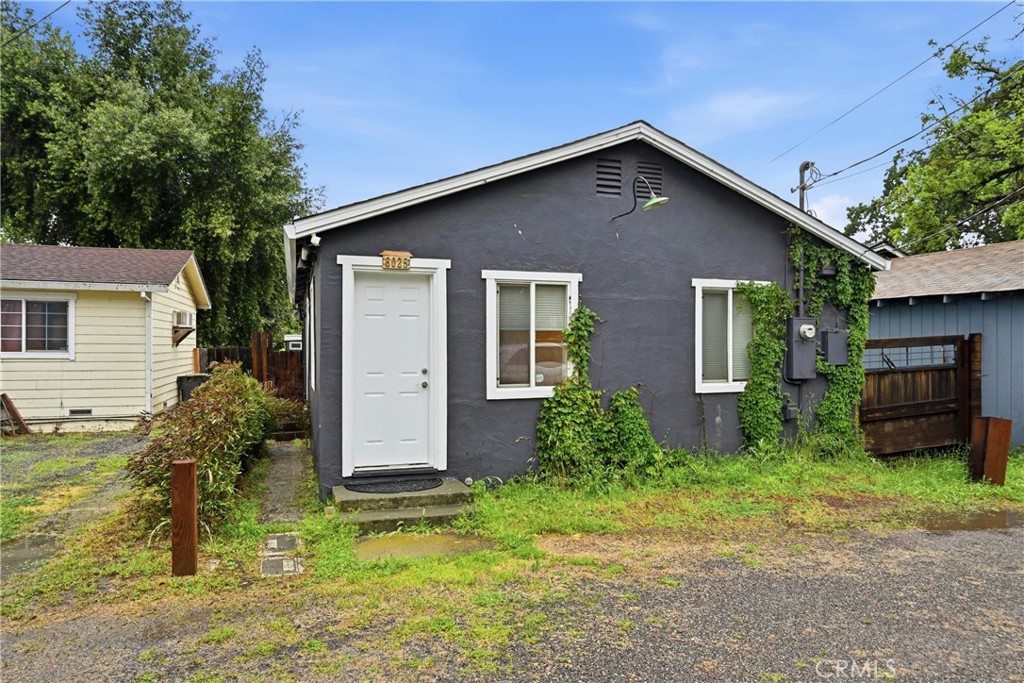 6025 Front Street Clearlake, CA 95422 - Photo 1 of 32 a front view of a house with garden