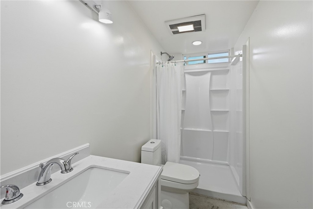 6025 Front Street Clearlake, CA 95422 - Photo 28 of 32 a bathroom with a sink toilet and shower