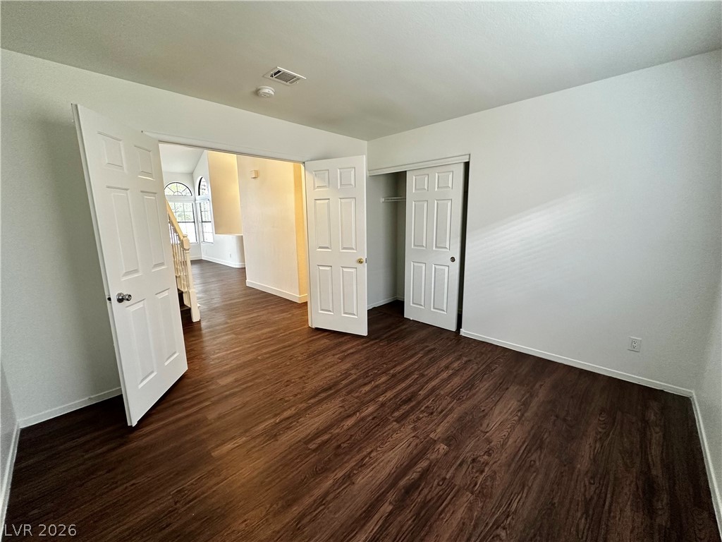 2113 Rico Peak Court Las Vegas, NV 89128 - Photo 22 of 53 Unfurnished bedroom with dark wood-style floors and a closet