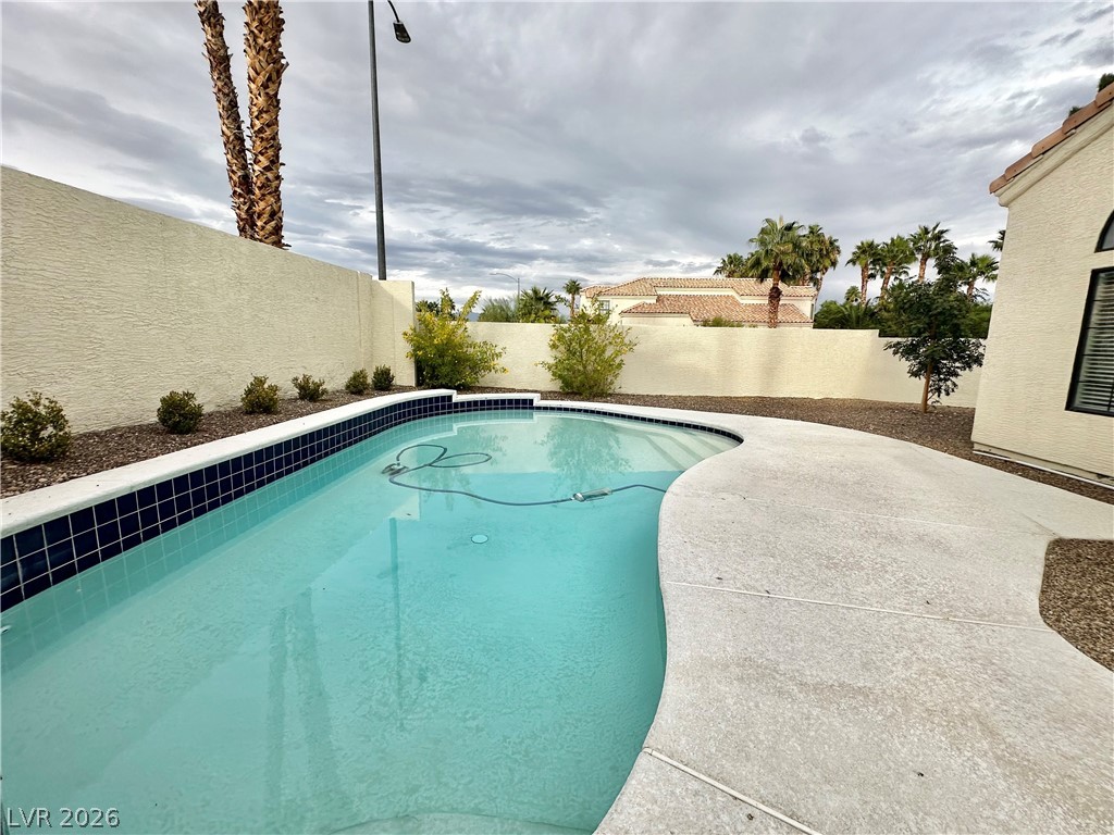2113 Rico Peak Court Las Vegas, NV 89128 - Photo 45 of 53 View of pool featuring a fenced backyard and patio surround