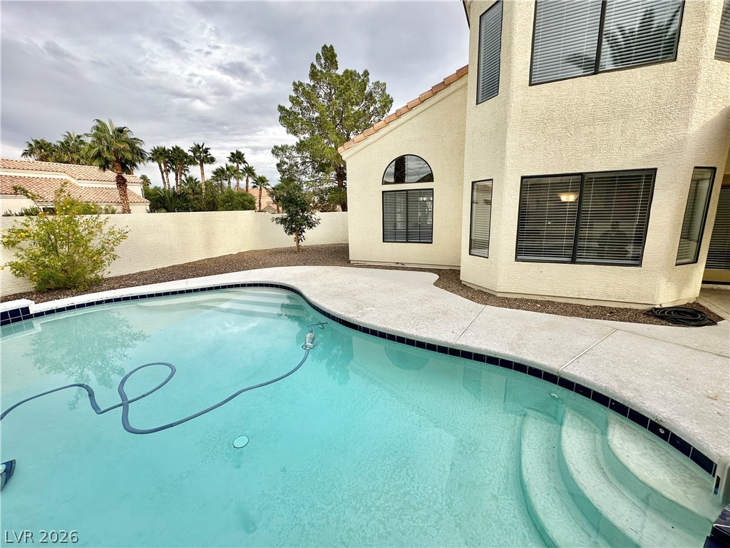 2113 Rico Peak Court Las Vegas, NV 89128 - Photo 46 of 53 View of swimming pool featuring patio surround and a fenced backyard