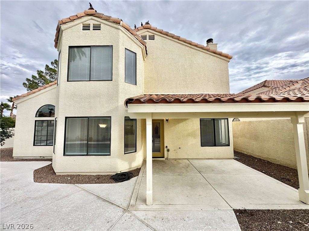 2113 Rico Peak Court Las Vegas, NV 89128 - Photo 48 of 53 Back of house featuring a tile roof, stucco siding, and a patio area