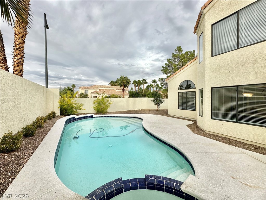 2113 Rico Peak Court Las Vegas, NV 89128 - Photo 50 of 53 Integrated pool / spa featuring a patio area and a fenced backyard