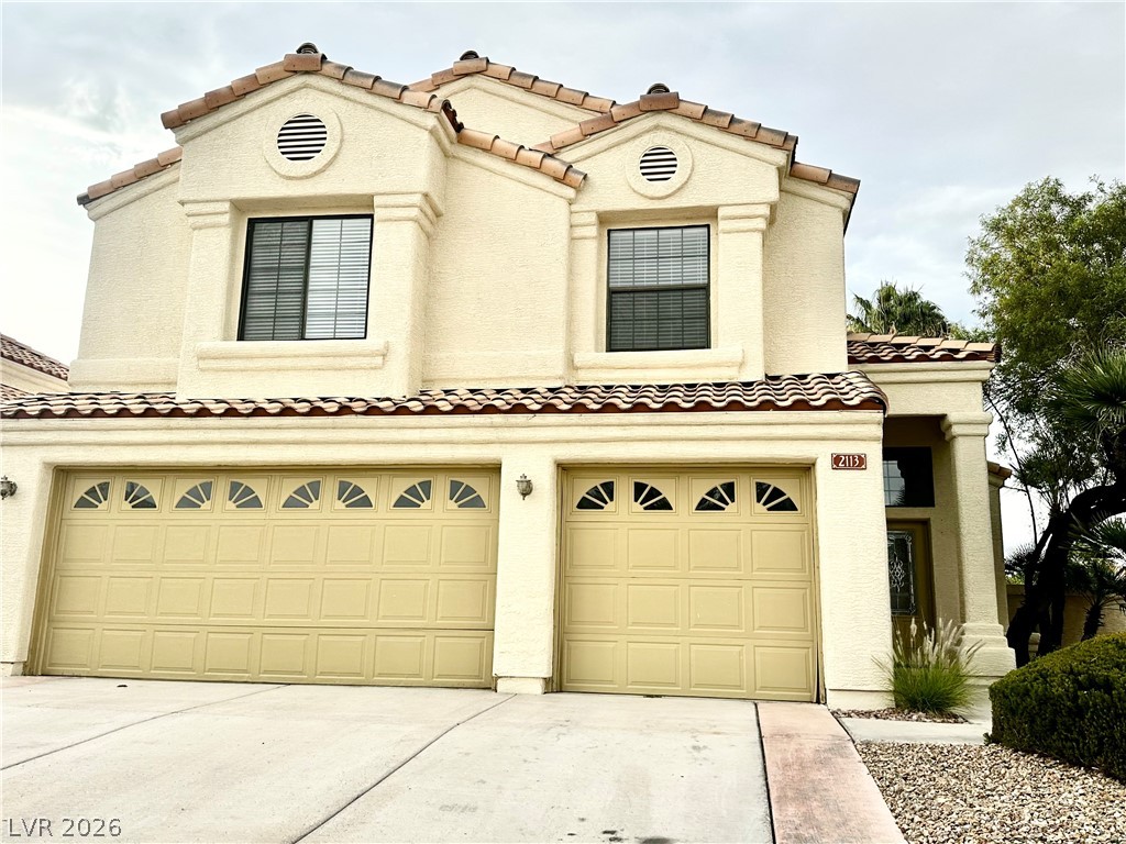 2113 Rico Peak Court Las Vegas, NV 89128 - Photo 53 of 53 Mediterranean / spanish house with a tiled roof, an attached garage, concrete driveway, and stucco siding