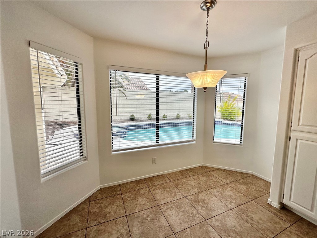 2113 Rico Peak Court Las Vegas, NV 89128 - Photo 8 of 53 Unfurnished dining area featuring light tile patterned floors and baseboards