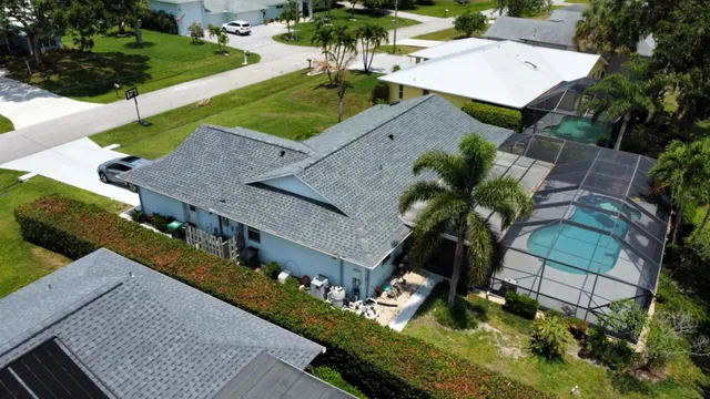 a living room with furniture a dining table and a chandelier