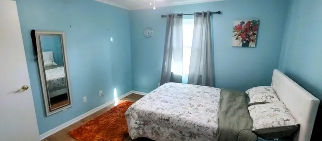 a view of a hallway with workspace and living room