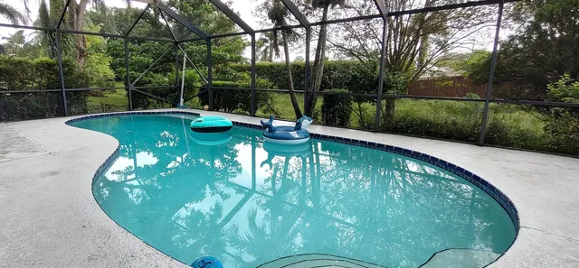 a backyard of a house with lots of green space and garden