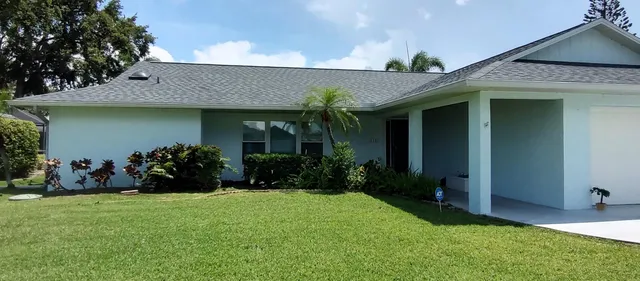 a living room with furniture a chandelier and a flat screen tv
