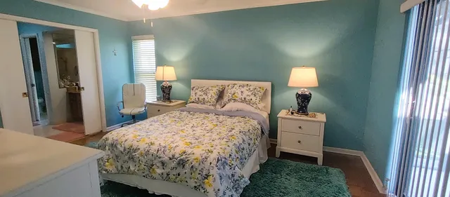 a bedroom with furniture and a window