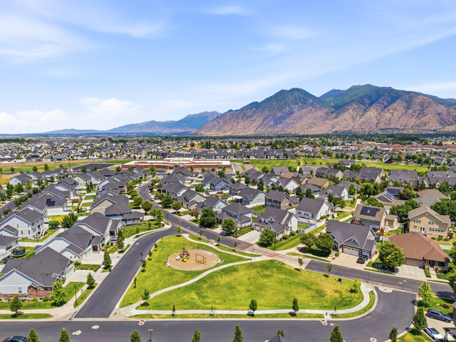 877 South Yarrow Drive Mapleton, UT 84664 - Photo 41 of 46 Expansive residential development featuring a community park, paved streets, and a mountainous backdrop