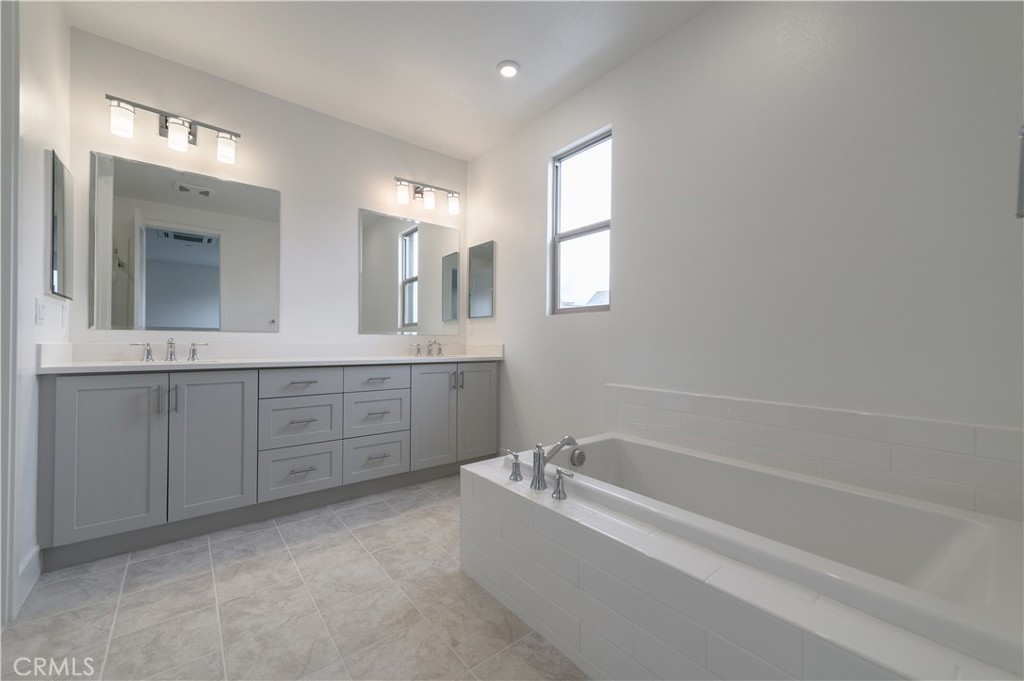 194 Abacus Irvine, CA 92618 - Photo 19 of 34 a bathroom with a bathtub sink and mirror