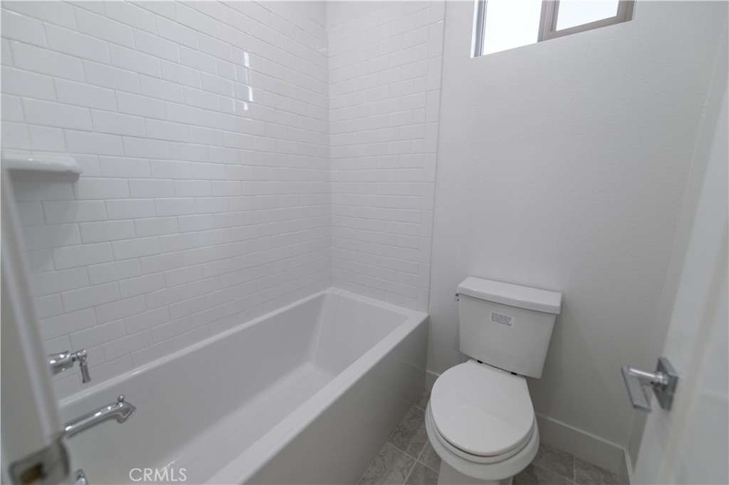 194 Abacus Irvine, CA 92618 - Photo 24 of 34 a white toilet and tub sitting next to a bathroom sink