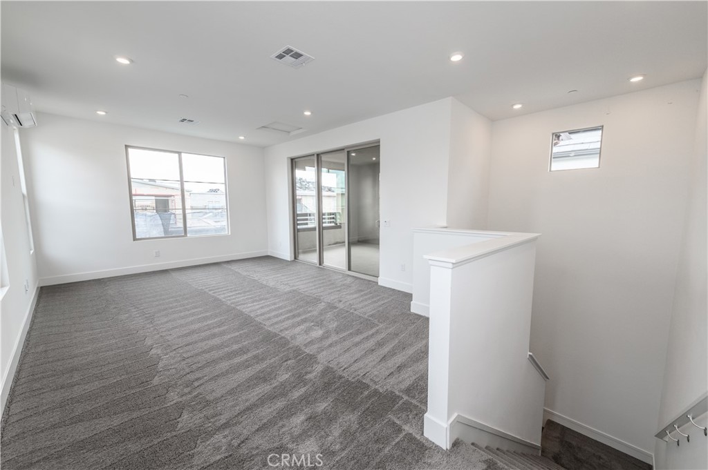 194 Abacus Irvine, CA 92618 - Photo 27 of 34 a view of an empty room with a window and wooden floor
