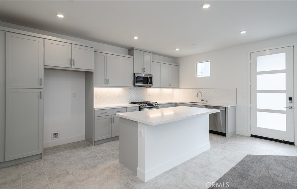 194 Abacus Irvine, CA 92618 - Photo 9 of 34 a kitchen with a sink stove and refrigerator