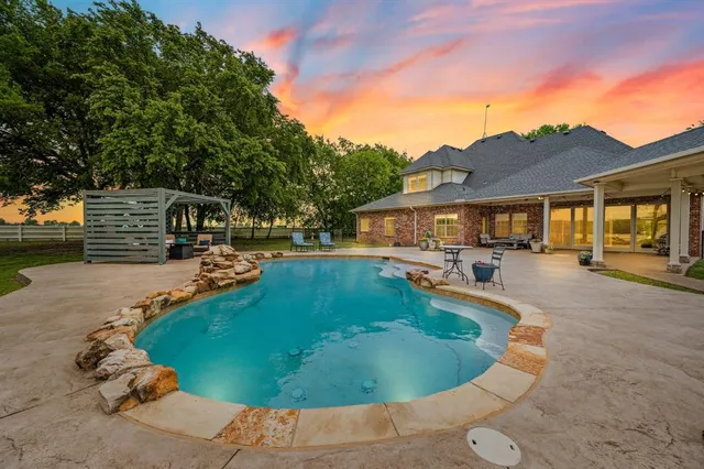 a view of a swimming pool with a patio