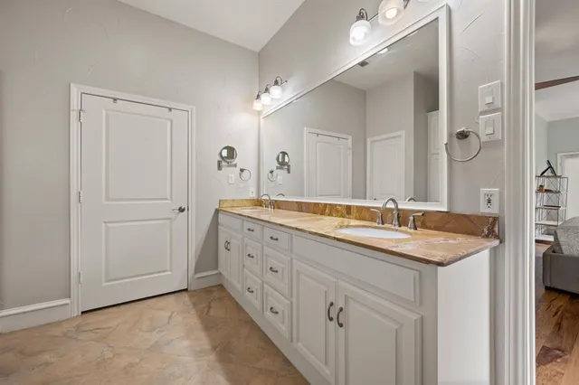 a spacious bathroom with a granite countertop sink a mirror a and a