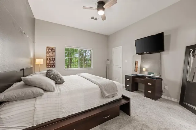 a bathroom with a granite countertop sink a toilet and a mirror