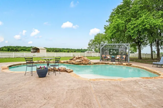 a view of backyard with seating space and yard
