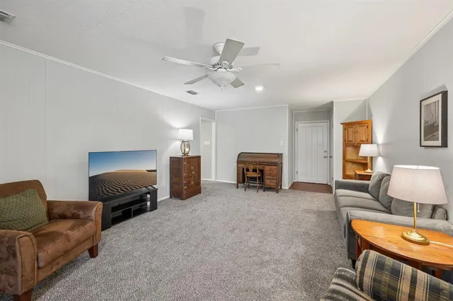 a living room with furniture and a lamp