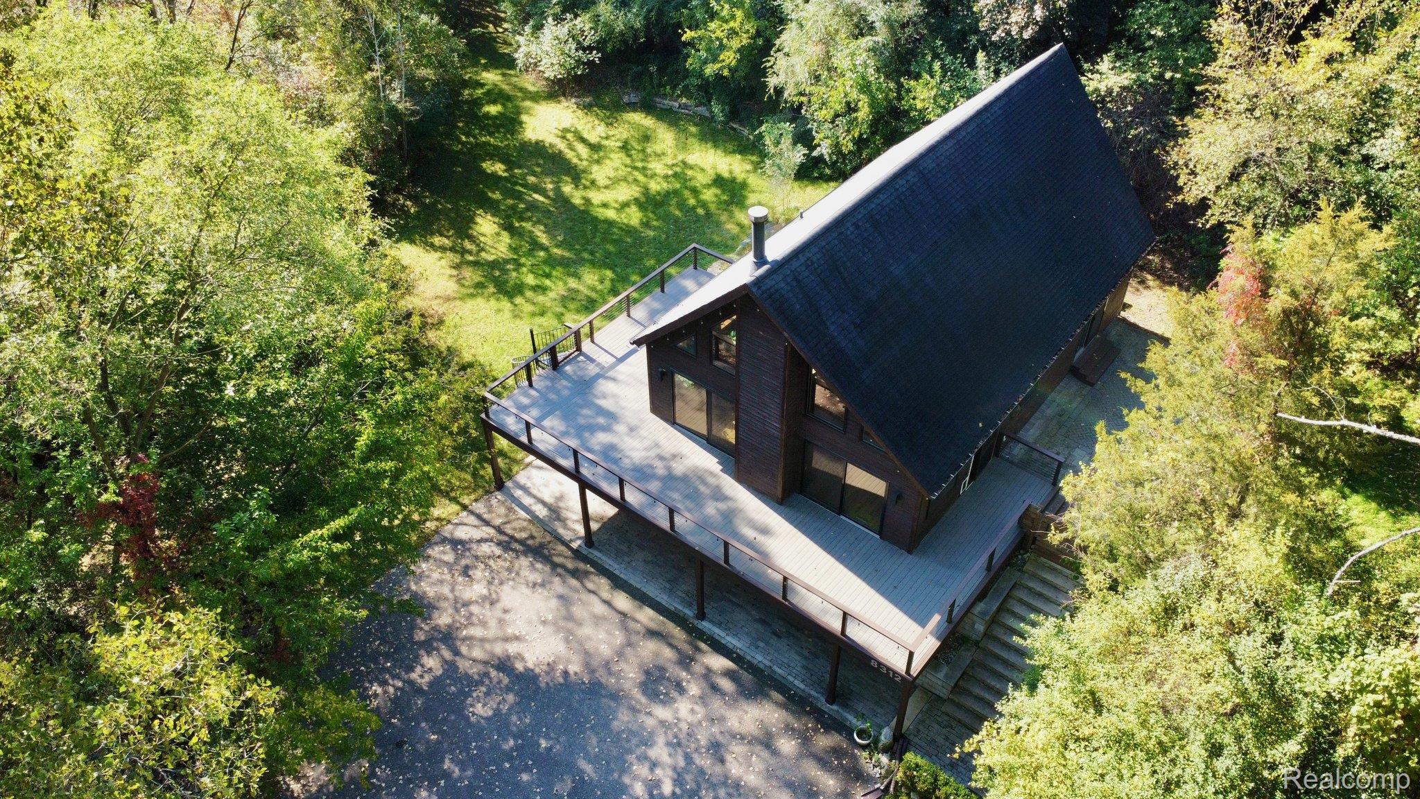 Wood-sided A-frame dwelling with a dark shingled roof