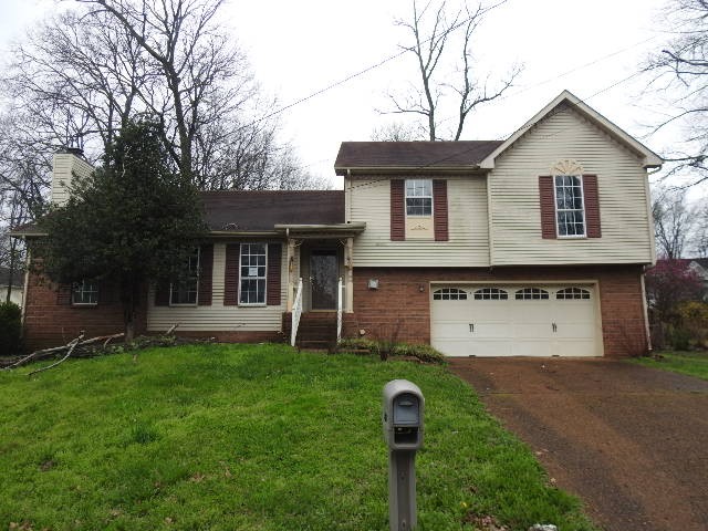 3405 Country Ridge Drive Antioch, TN 37013 - Photo 1 of 19 a front view of a house with a garden and yard