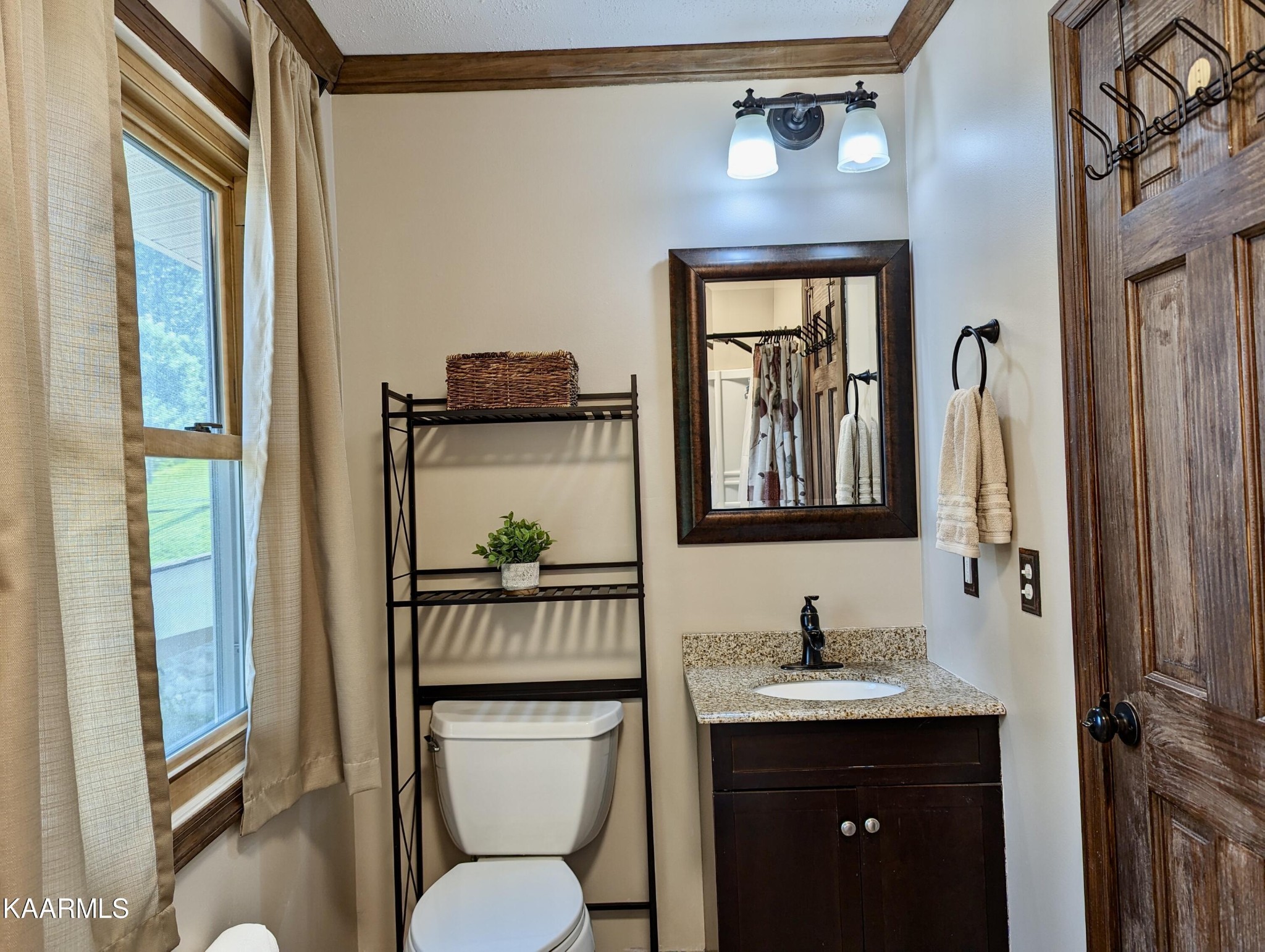 4518 Cloverdale Loop Hixson, TN 37343 - Photo 14 of 24 a bathroom with a granite countertop sink toilet and a mirror