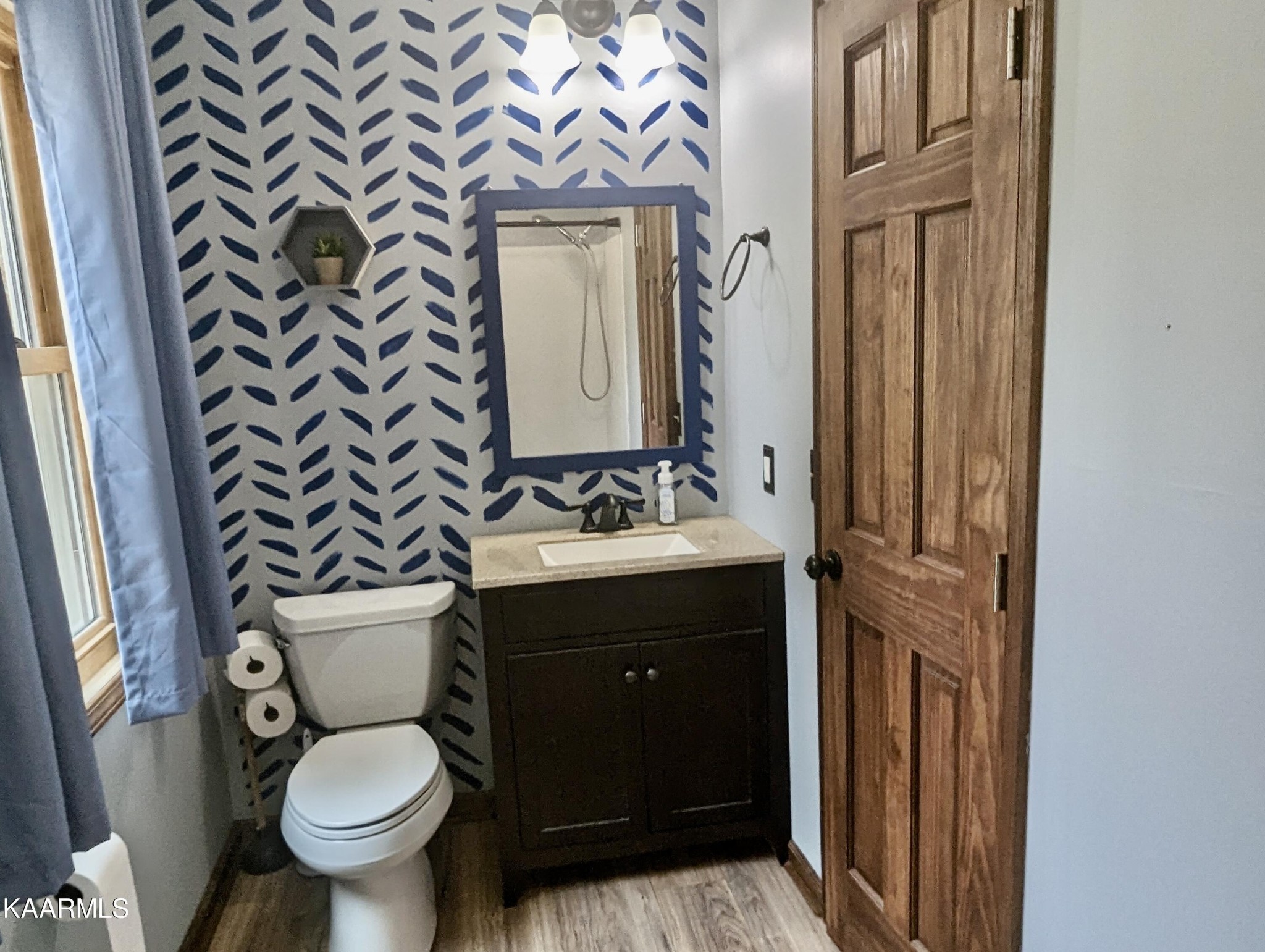 4518 Cloverdale Loop Hixson, TN 37343 - Photo 19 of 24 a bathroom with a toilet sink and mirror