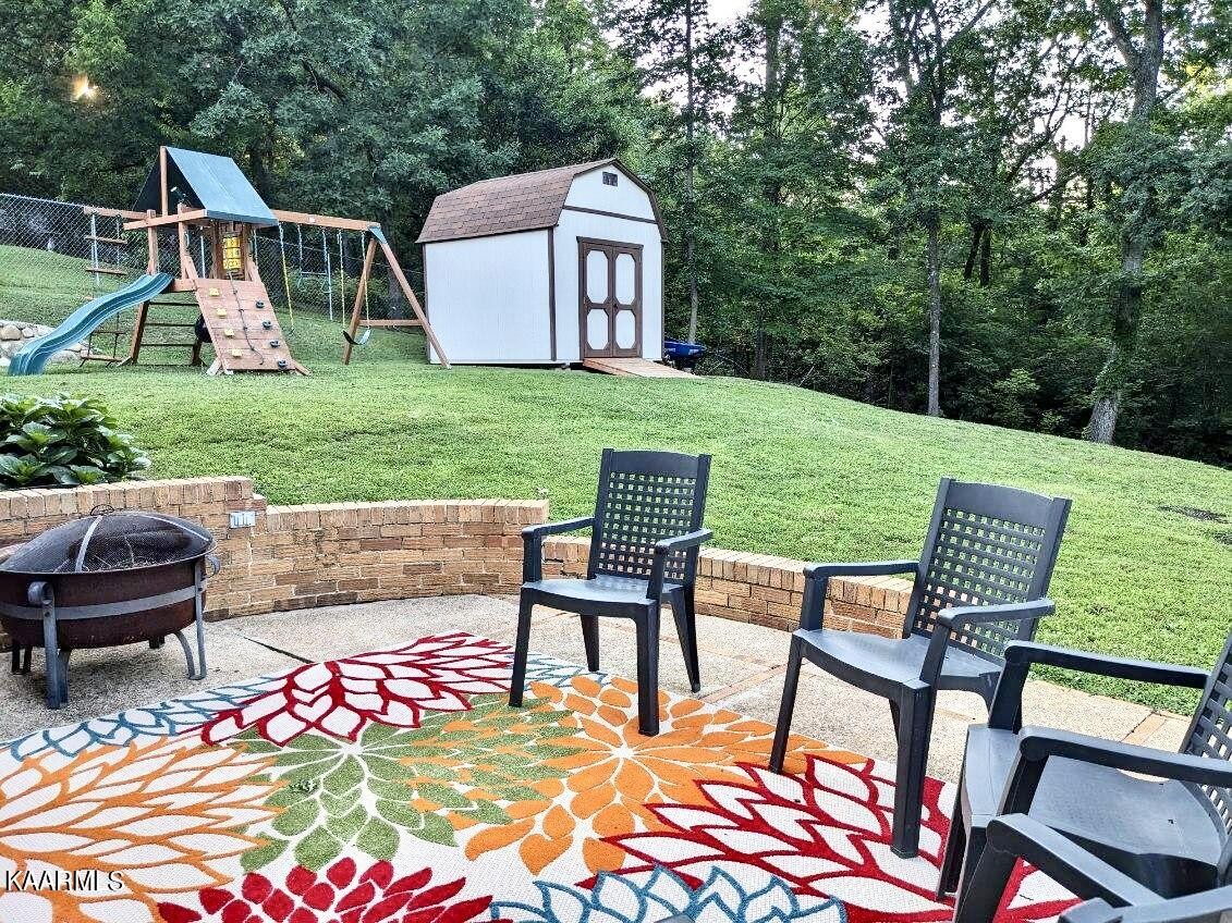 4518 Cloverdale Loop Hixson, TN 37343 - Photo 20 of 24 a view of a chairs and table in backyard of the house