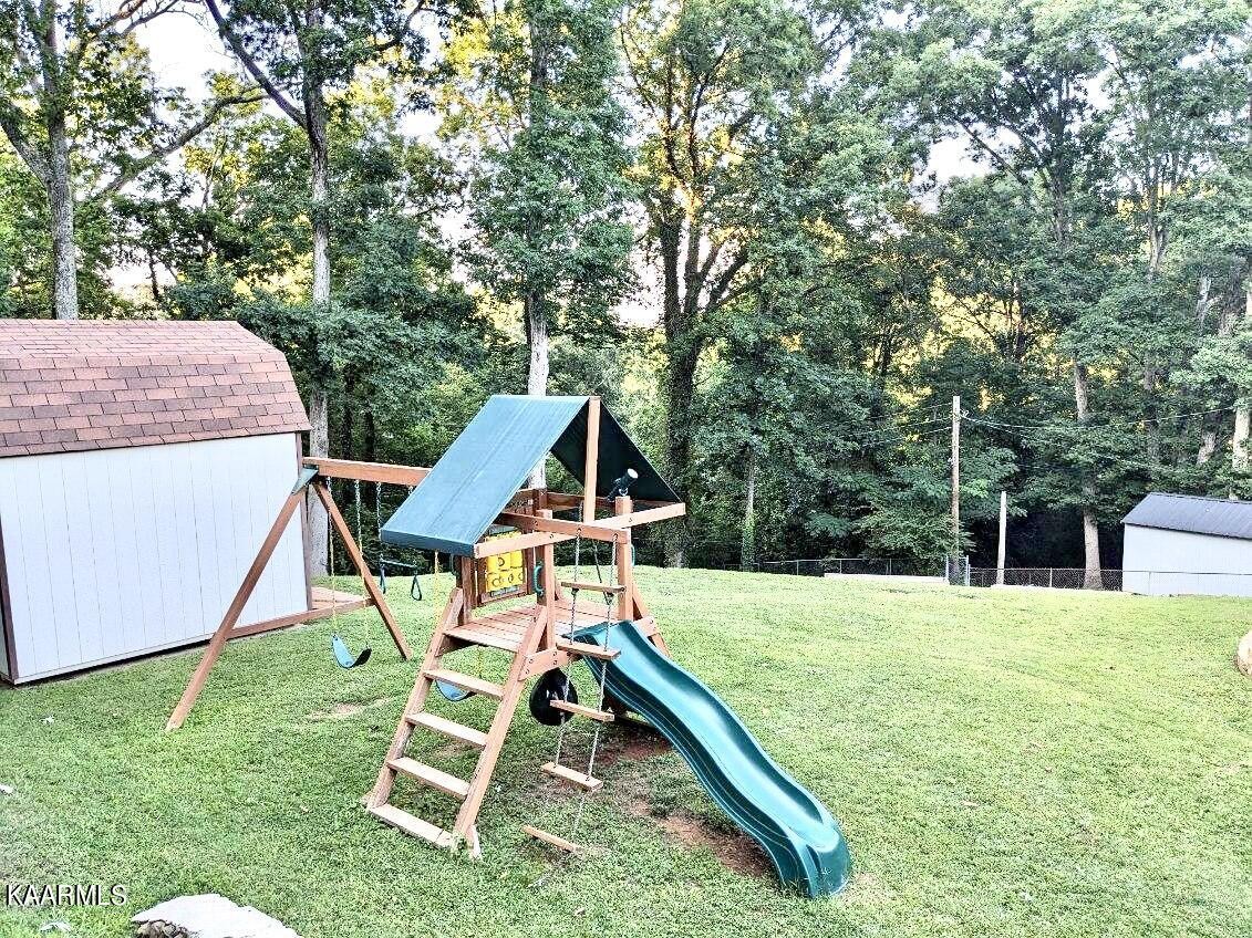 4518 Cloverdale Loop Hixson, TN 37343 - Photo 24 of 24 a view of a backyard with chairs and wooden fence