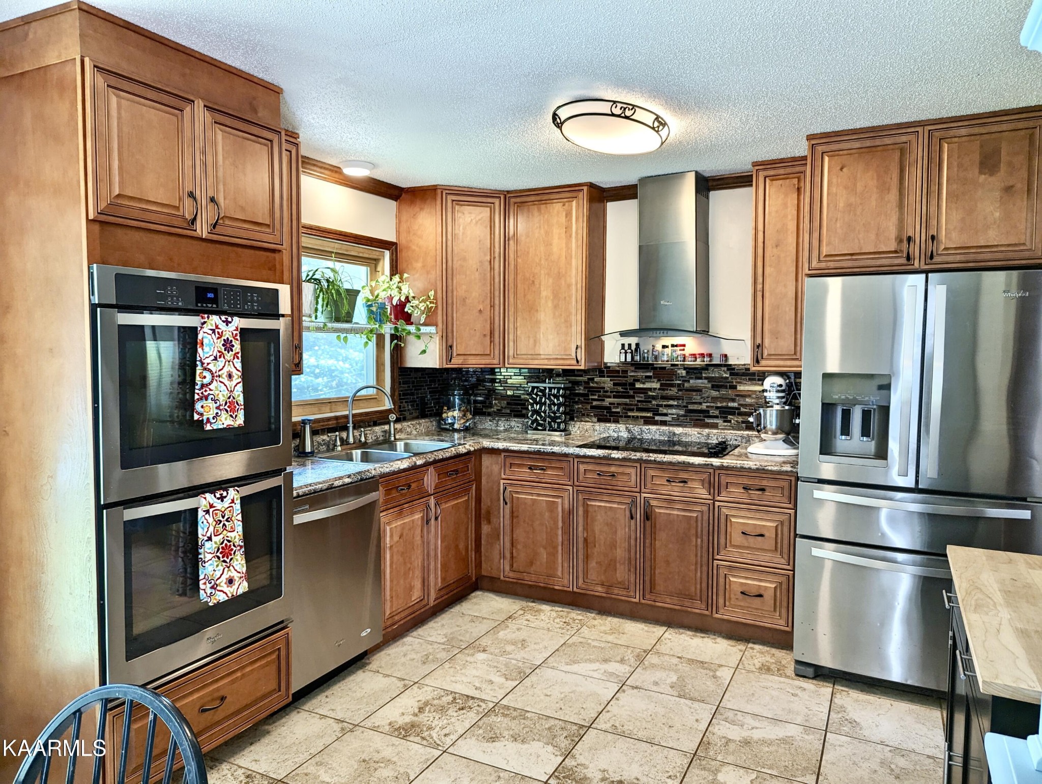 4518 Cloverdale Loop Hixson, TN 37343 - Photo 7 of 24 a kitchen with stainless steel appliances granite countertop a refrigerator a stove and a sink with large cabinets