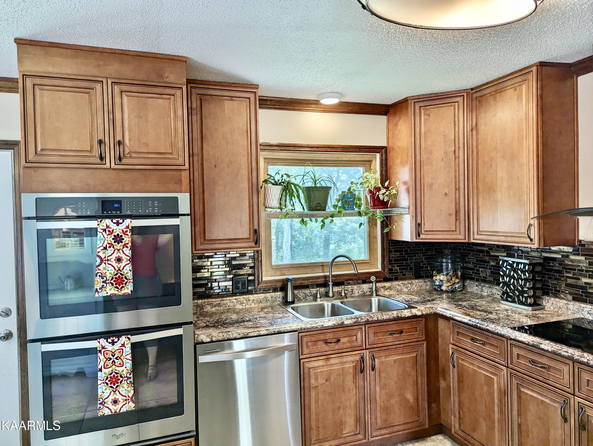 4518 Cloverdale Loop Hixson, TN 37343 - Photo 10 of 24 a kitchen with stainless steel appliances granite countertop a stove a sink and a microwave