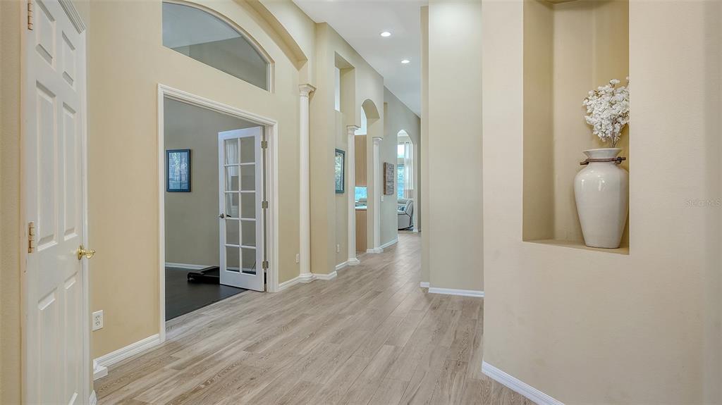 7717 US Open Loop Lakewood Ranch, FL 34202 - Photo 5 of 95 a view of a hallway with wooden floor and a bathroom