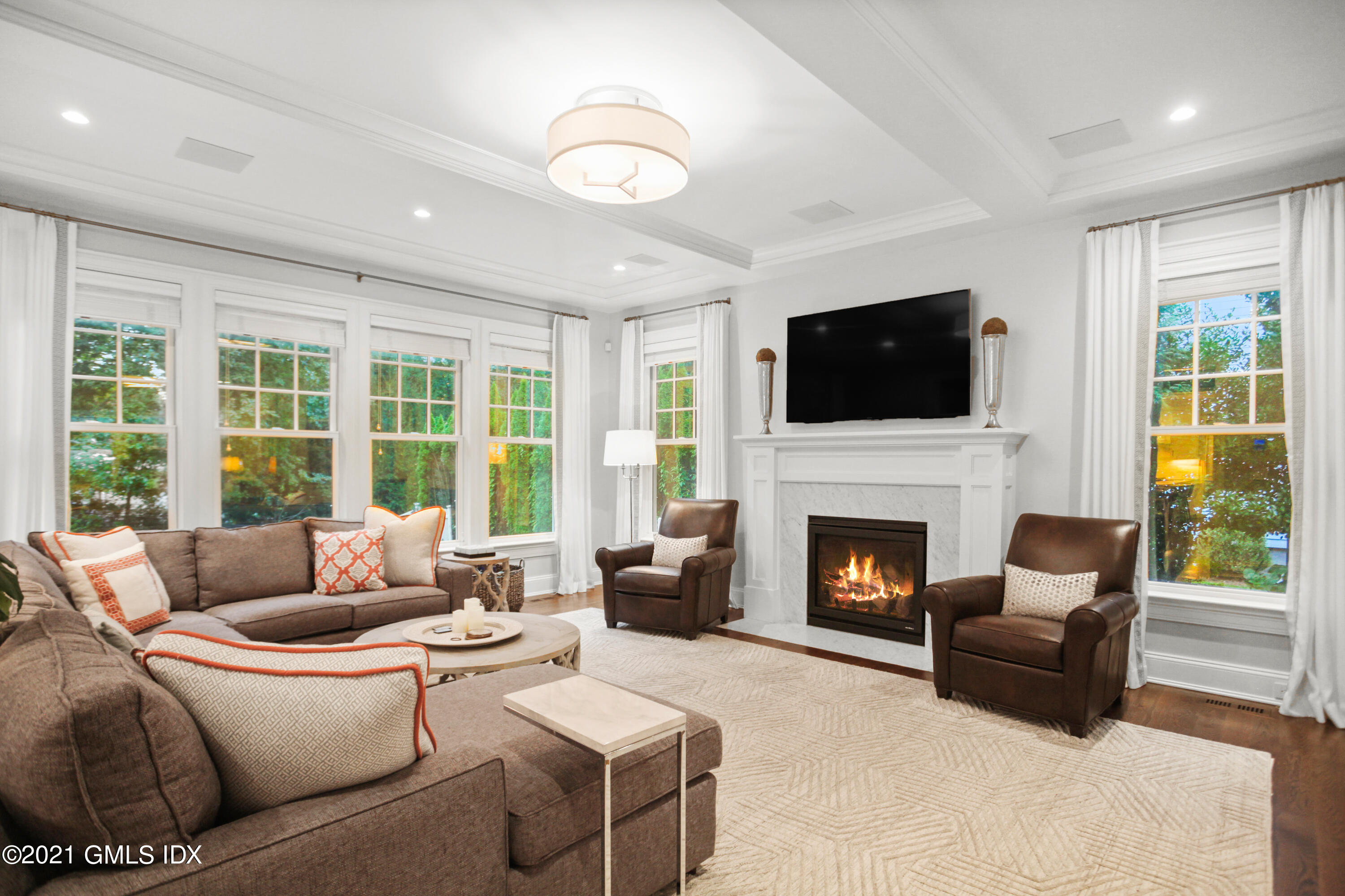 48 Winthrop Drive Riverside, CT 06878 - Photo 12 of 40 a living room with furniture a fireplace and a flat screen tv