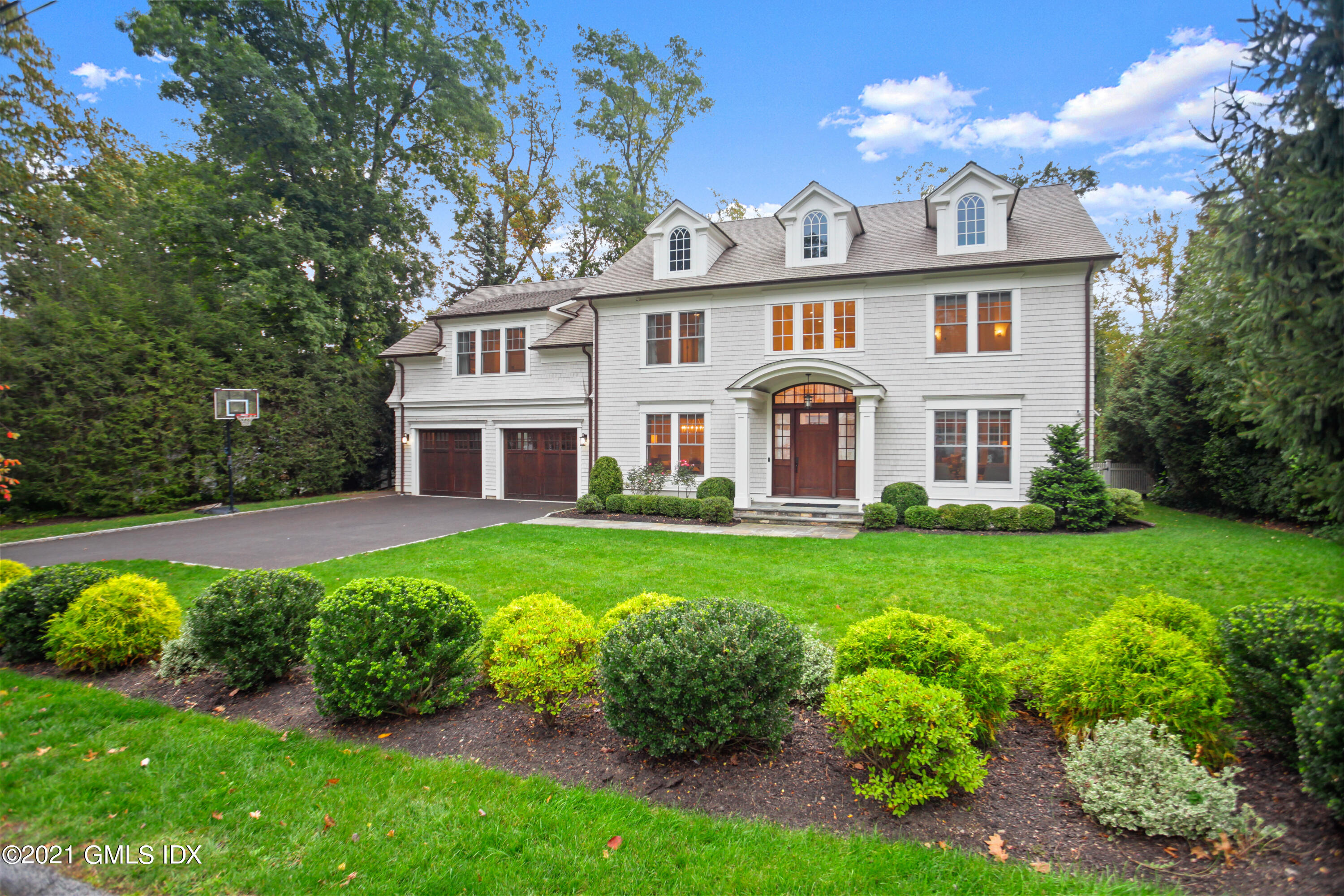 48 Winthrop Drive Riverside, CT 06878 - Photo 2 of 40 a front view of a house with a yard table and chairs