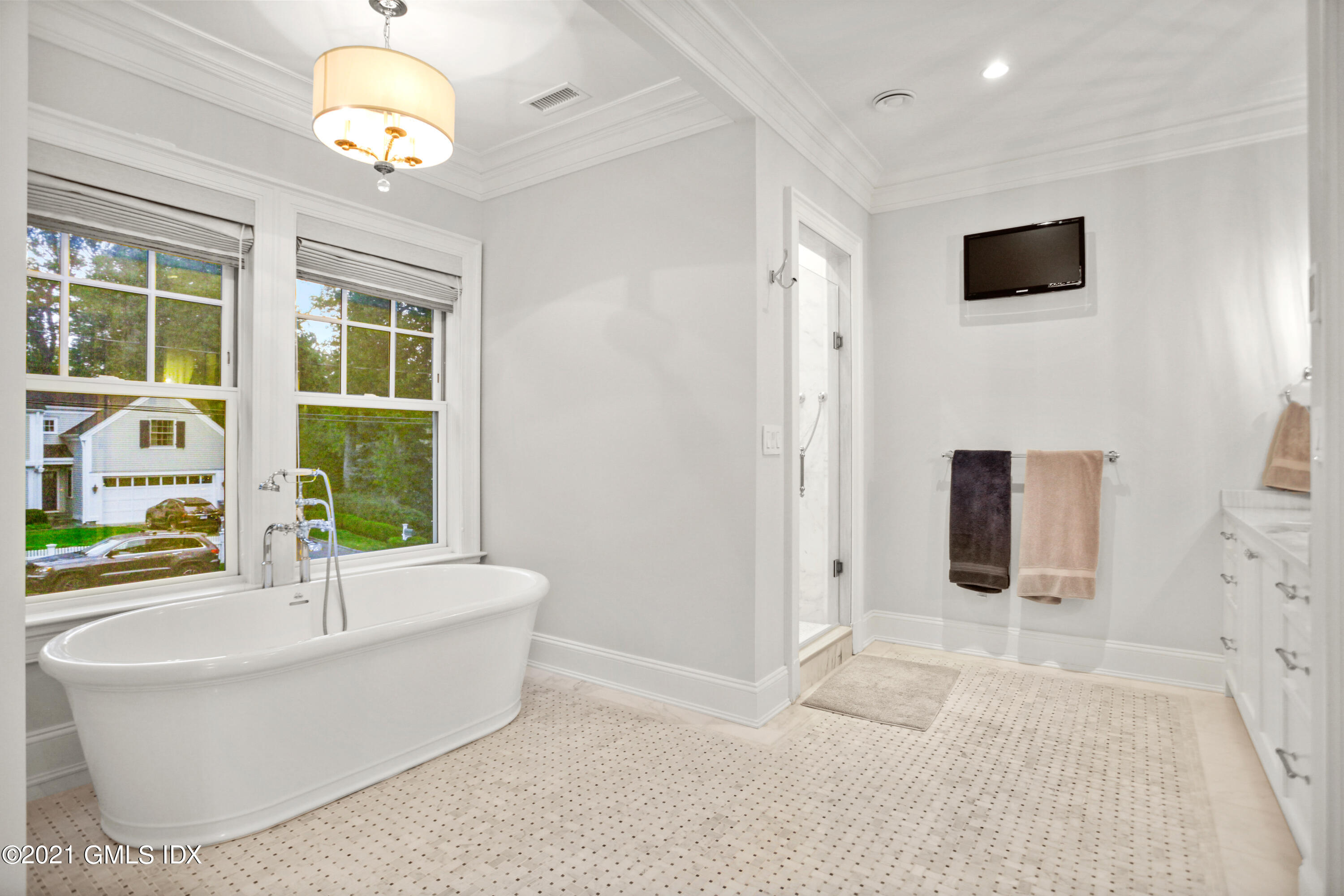 48 Winthrop Drive Riverside, CT 06878 - Photo 21 of 40 a bathroom with a bathtub and a chandelier