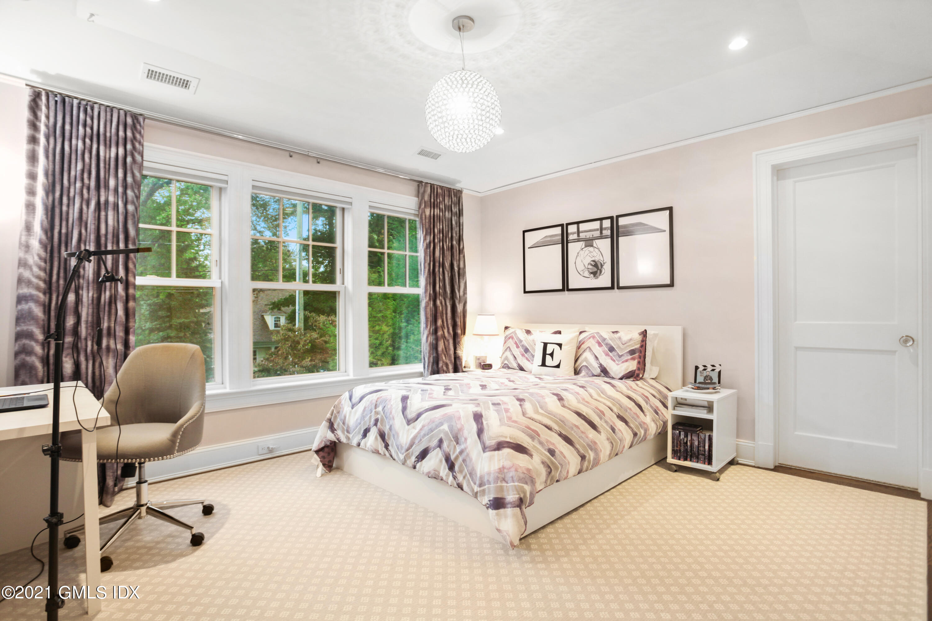 48 Winthrop Drive Riverside, CT 06878 - Photo 28 of 40 a bedroom with a bed a couch and a chandelier