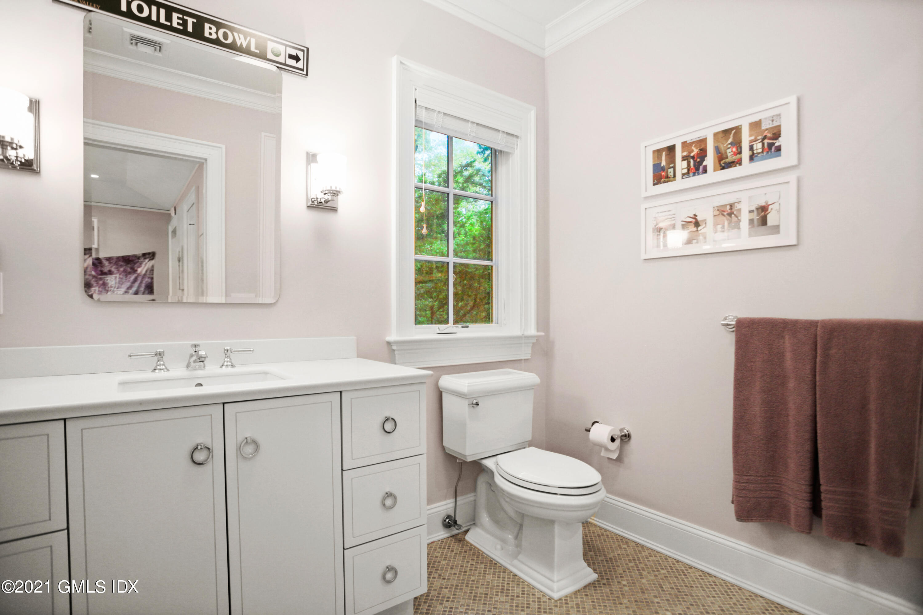 48 Winthrop Drive Riverside, CT 06878 - Photo 29 of 40 a bathroom with a toilet a sink a mirror and a window
