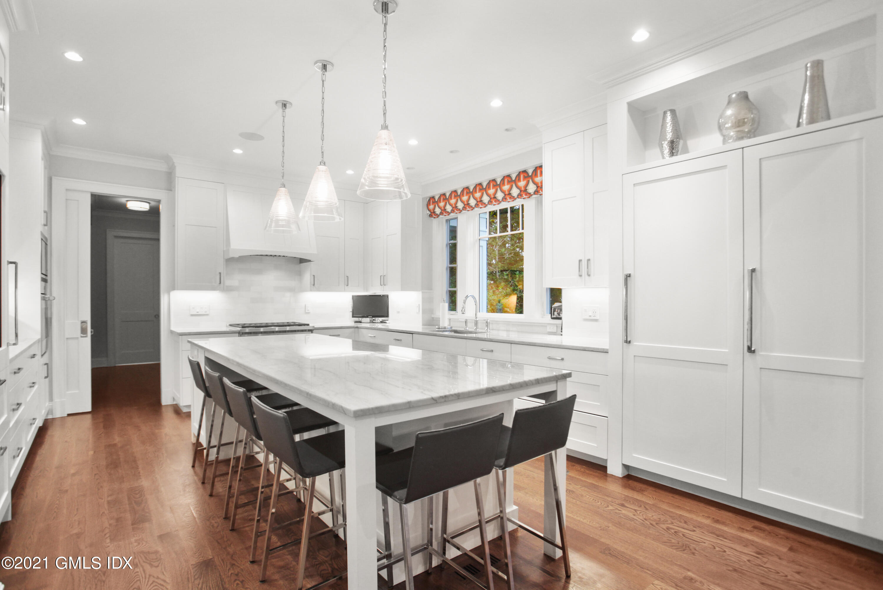 48 Winthrop Drive Riverside, CT 06878 - Photo 7 of 40 a kitchen with stainless steel appliances granite countertop a stove a sink a refrigerator and a dining table with wooden floor