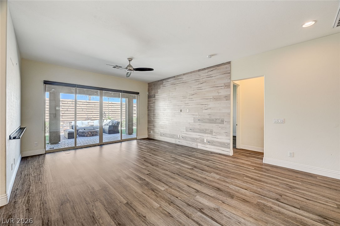 8197 Riley Love Street Las Vegas, NV 89139 - Photo 23 of 48 Floor-to-ceiling glass sliders reveal an inviting outdoor patio perfect for relaxation and entertainment.