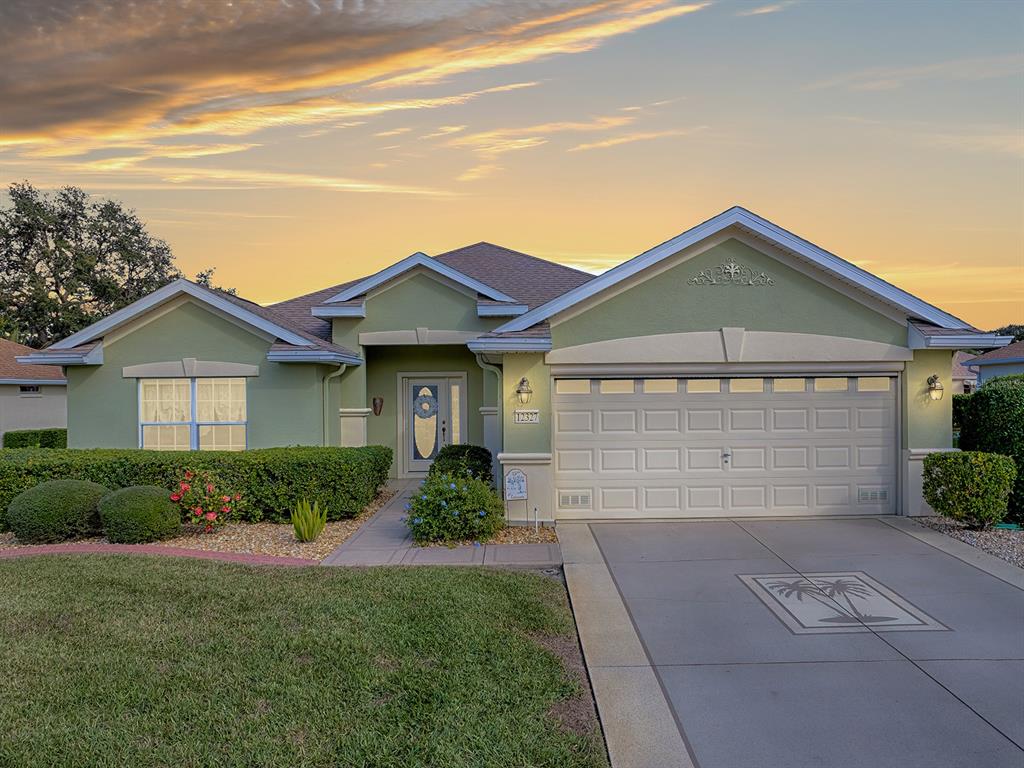 12327 Southeast 92nd Court Road Summerfield, FL 34491 - Photo 1 of 1 a front view of a house with a yard and garage