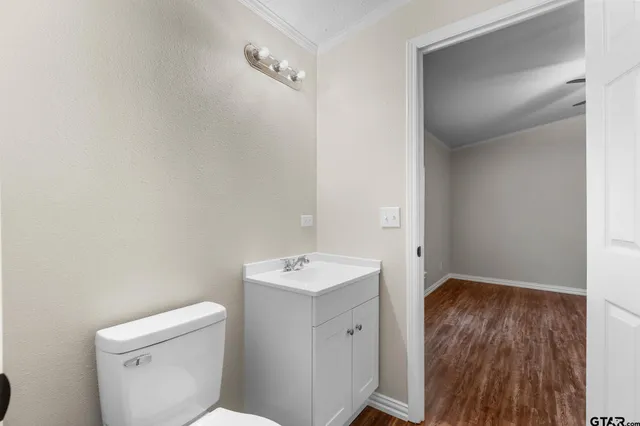 a bathroom with a toilet sink and mirror