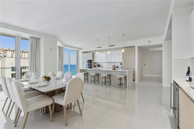 a view of a dining room with furniture and a large window