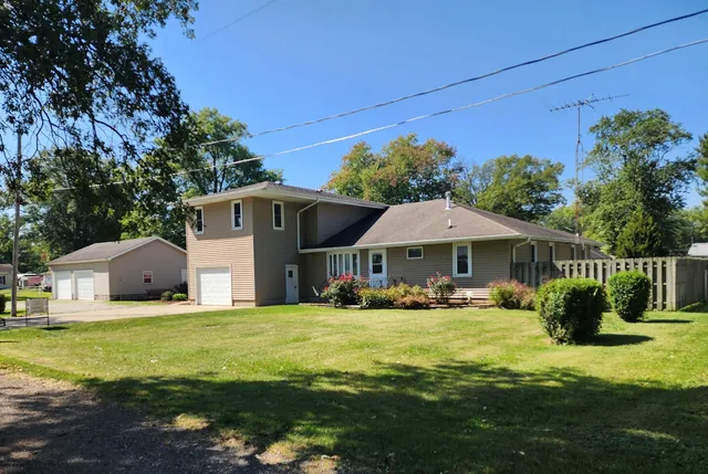 a front view of a house with yard and green space