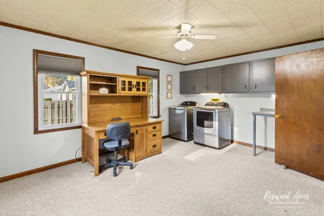 a view of a livingroom with furniture and a workspace
