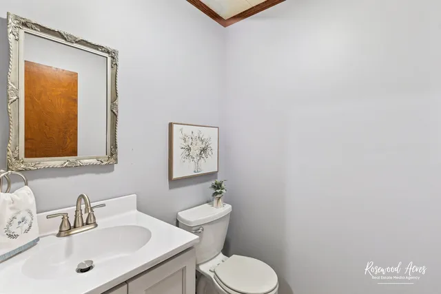 a bathroom with a sink mirror and toilet
