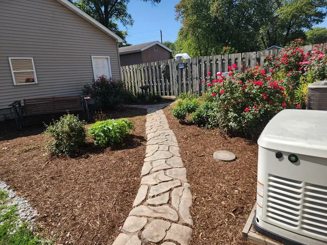 a view of a backyard with potted plants and a fountain
