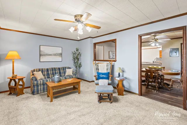 a living room with furniture and a chandelier