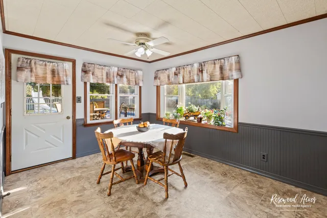 a view of a dining room with furniture large windows and wooden floor